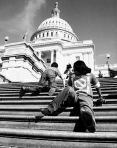 ADA protesters sitting on the steps of the capital building.