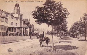 Historic postcard shows Palais Stoclet and the streetscape, including horse and rider.