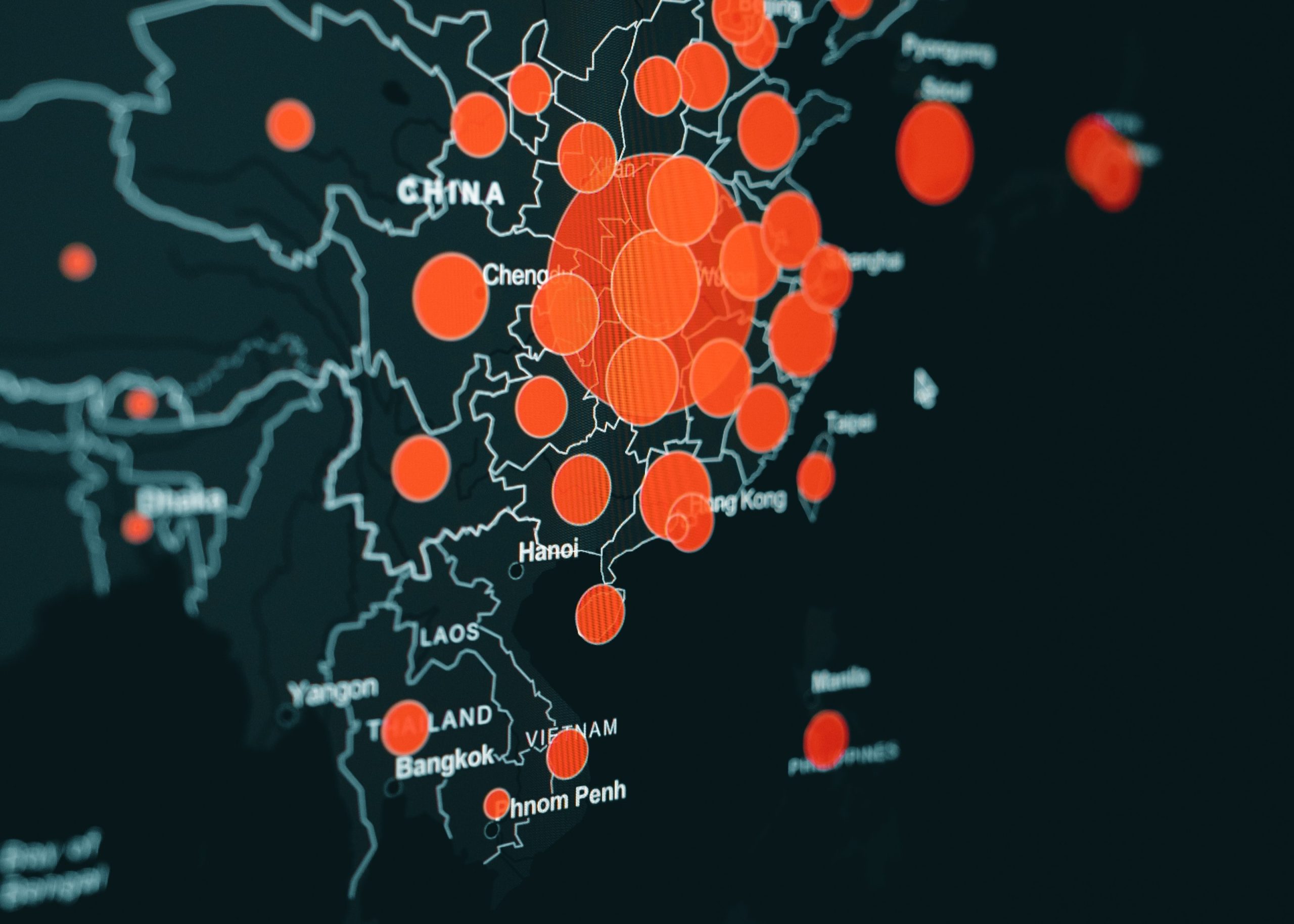 A digital map of east Asia with the countries outlined in teal on a black ground and numerous red-orange circles representing unknown data points on the map.