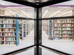 Inside the glass elevator in Steely Library looking out at the collection of books